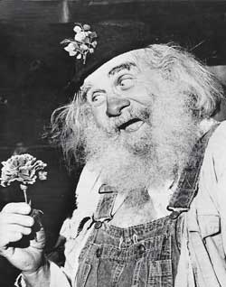 Shad Heller in costume holding a flower